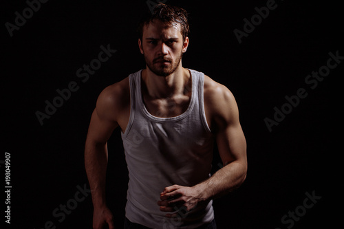 closeup photo of jogging man on the black background. going in for sport. motivation