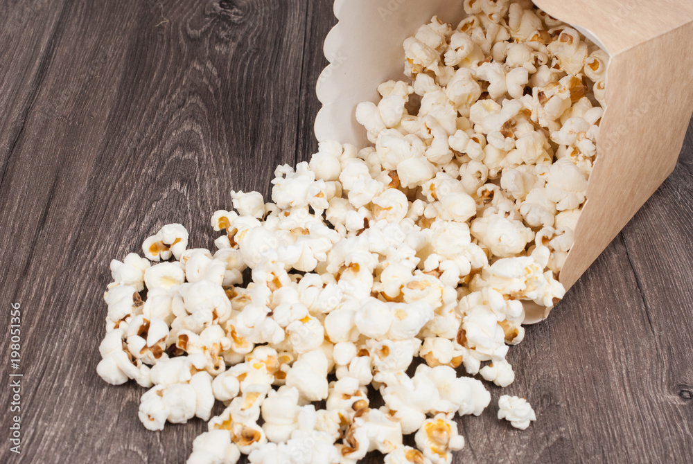 delicious popcorn on the wooden table delicious popcorn on the wooden table