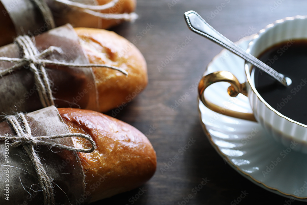 Fototapeta premium Freshly baked French baguette on a wooden table