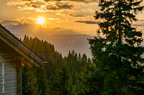 Austrian lodge at dusk in the forest mountains