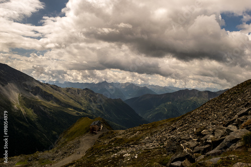 Winding valley view below rolling clouds
