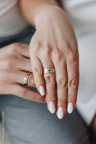 Groom and and bride hands with rings