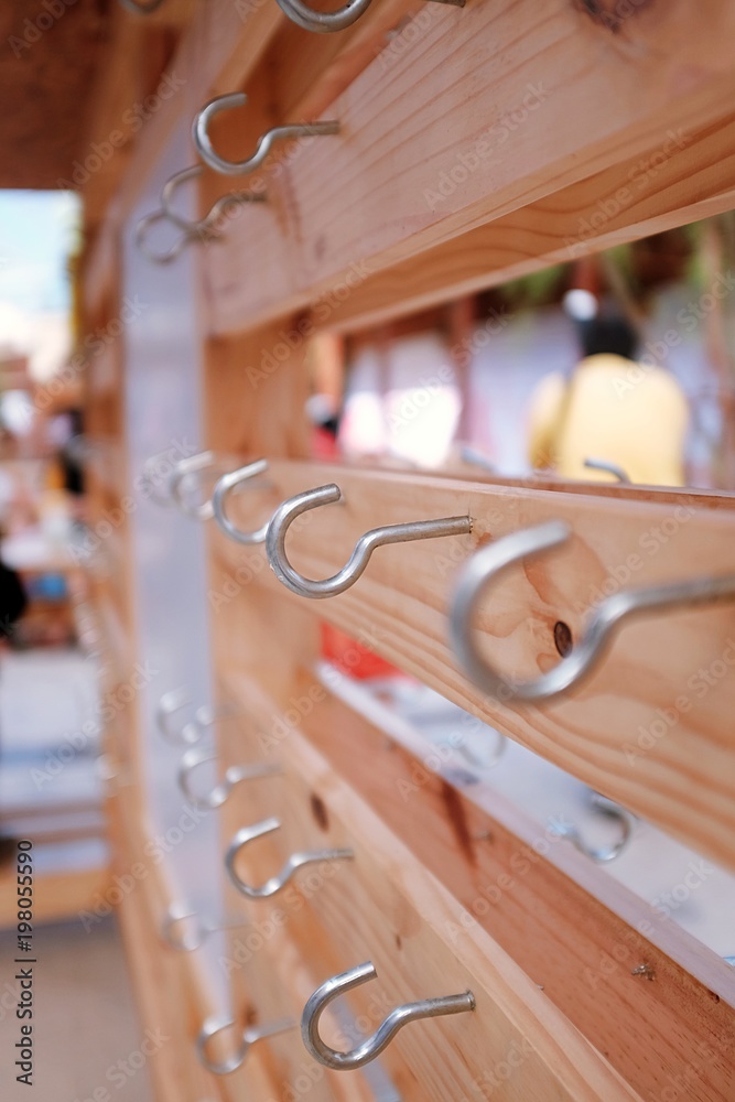 Close up row of empty hooks, A series of hooks, for hanging items, that's  fixed on wooden board. Stock Photo | Adobe Stock