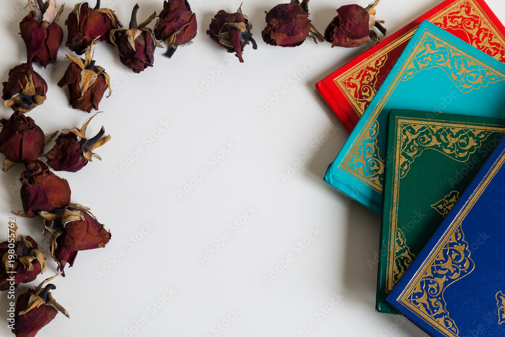 Holy book for Muslims. Quran and roses  concept. Ramadan concept. Three months.colorful quran on the white background. 