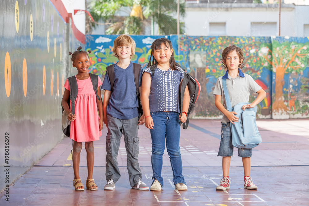 Multi ethnic group of young children playing at school