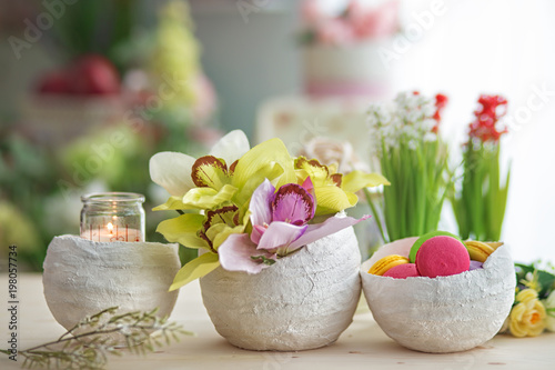 Spring flowers and sweets on a wooden table. Spring mood.