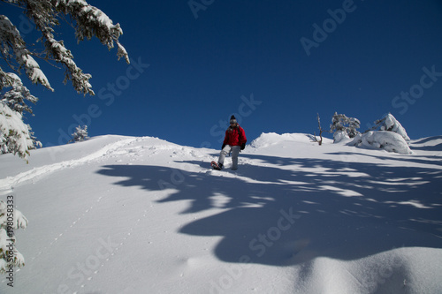 Snowshoe hiker descends from the Paha-Koli peak in deep snow © nidafoto