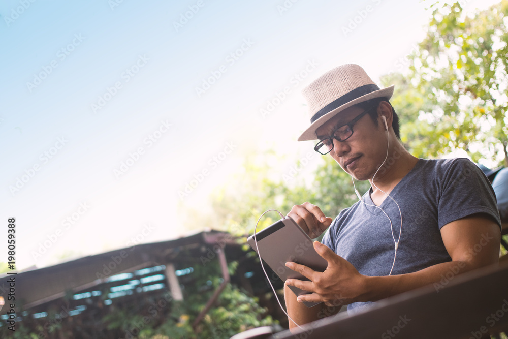 Asian men using a tablet in coffee shop. Asian men using a tablet in coffee shop.