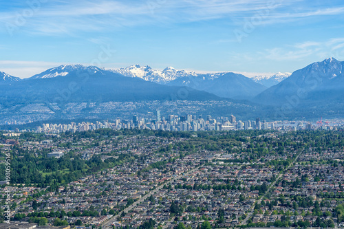 Aerial view of Vancouver downtown city in British Columbia with Snowcapped Mountaain and Clear Sky photo