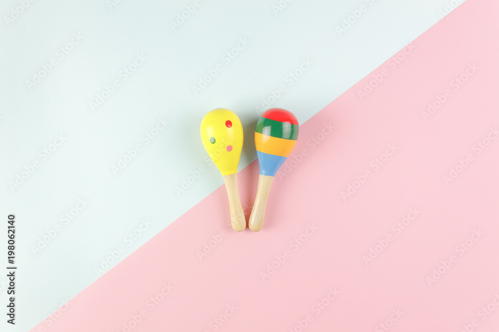 Table top view kids toys for develop background concept.Flat lay objects the colorful wooden ball percussion musical instruments on modern duo paper blue & pink at office desk.Design pastel tone.