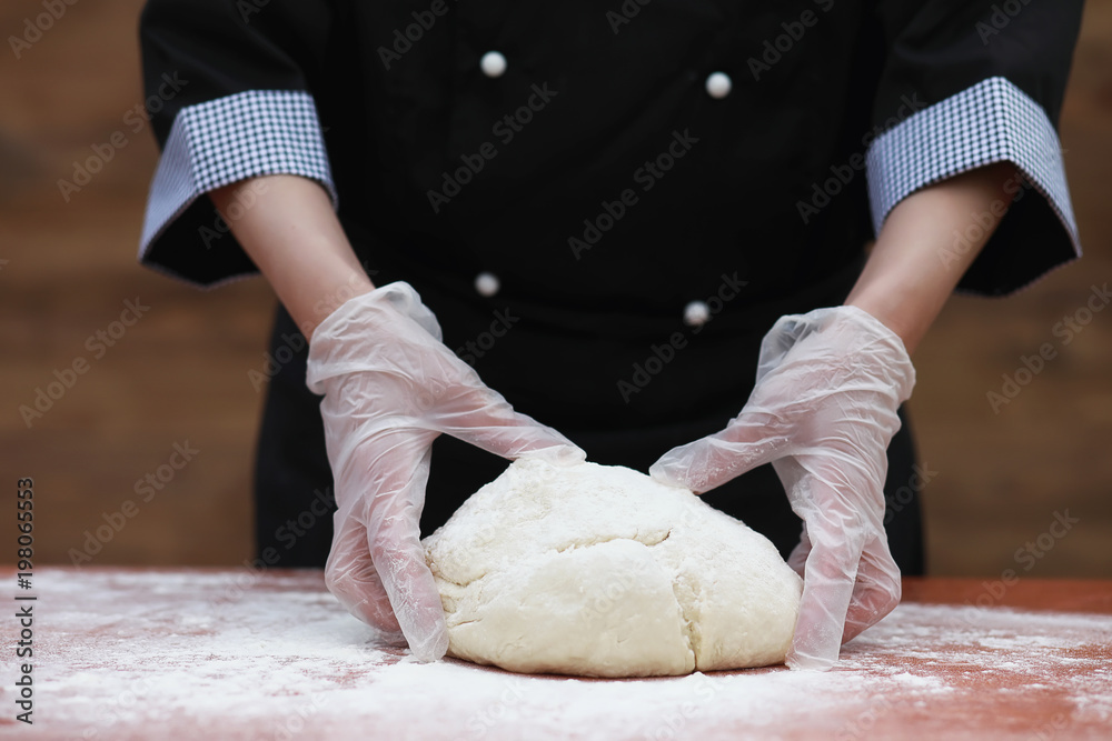 the cook makes flour for baking on the table