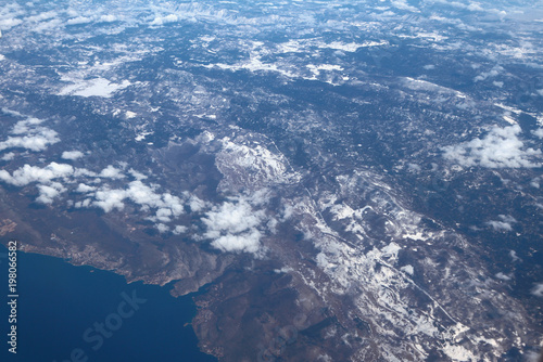 Snow-covered hilly terrain and Adriatic coast, aerial photograph. Croatia