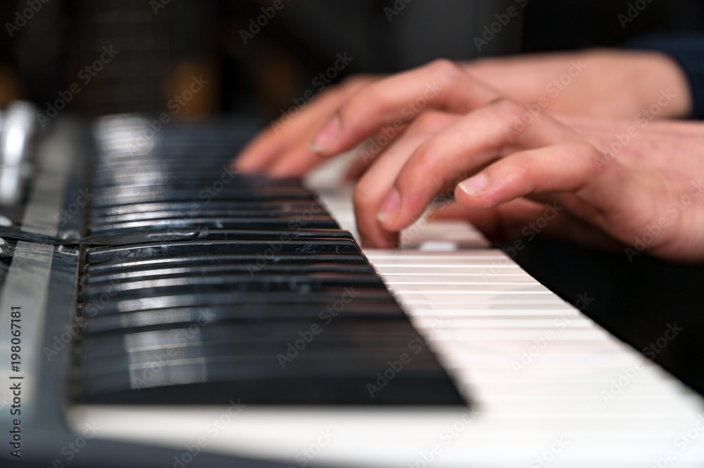 Hands of a pianist close-up. Plays on the synthesizer. Selective focus Hands of a pianist close-up. Plays on the synthesizer. Selective focus
