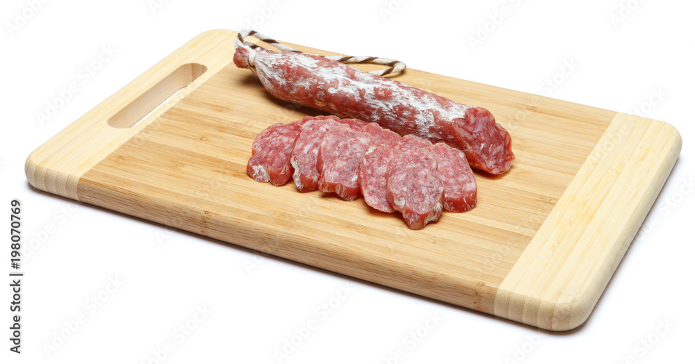 Dried sliced organic salami sausage on wooden cutting board Dried sliced organic salami sausage on wooden cutting board
