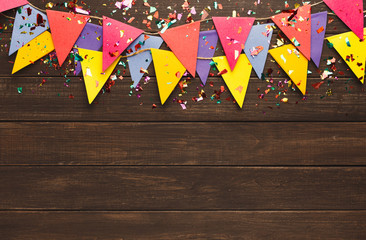 Colorful flags garland on wooden background