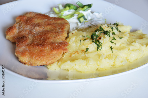 pork chop in bread crumbs, boiled potatoes with dill, leek salad with sour cream and mayonnaise,