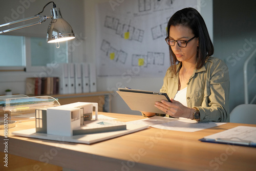 Architect woman in office working on digital tablet