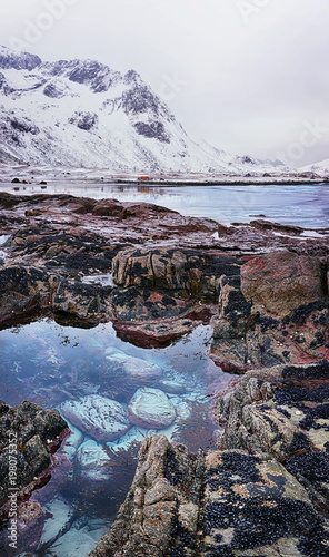 Beautiful Norway landscape of picturesque stones on the arctic beach of cold Norwegian Sea
