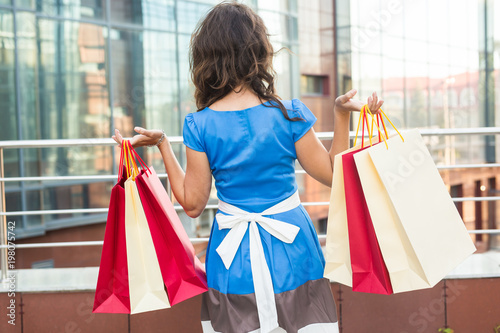 happiness, consumerism, sale and people concept - woman with shopping bags