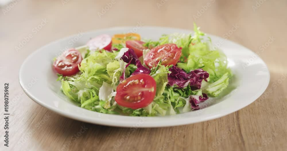 Slow motion adding paprika pepper to salad leaves Slow motion adding paprika pepper to salad leaves