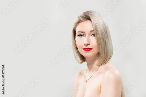 Portrait of beautiful female model on grey background