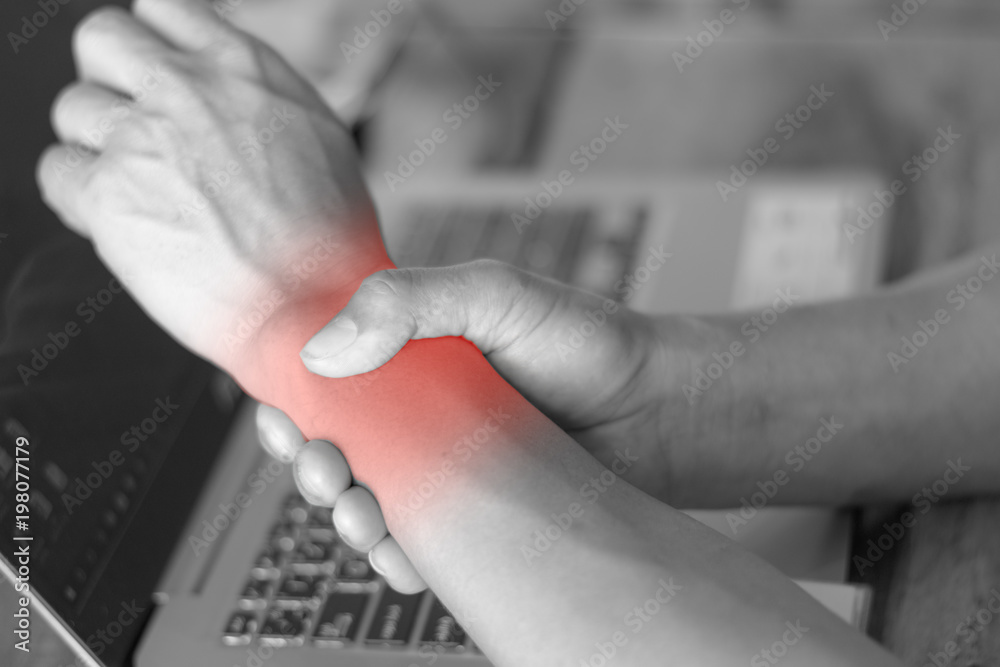 man holding her wrist pain from using computer. Office syndrome hand