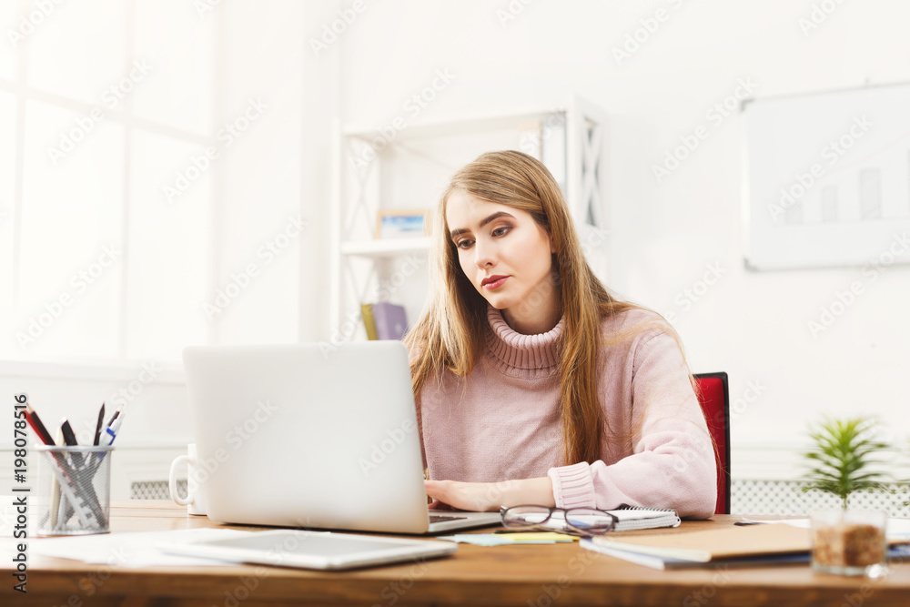 Business woman working on laptop at office Business woman working on laptop at office