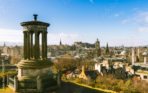 Romanic building with view over the old town of Edinburgh in the background seen from Carlton Hill