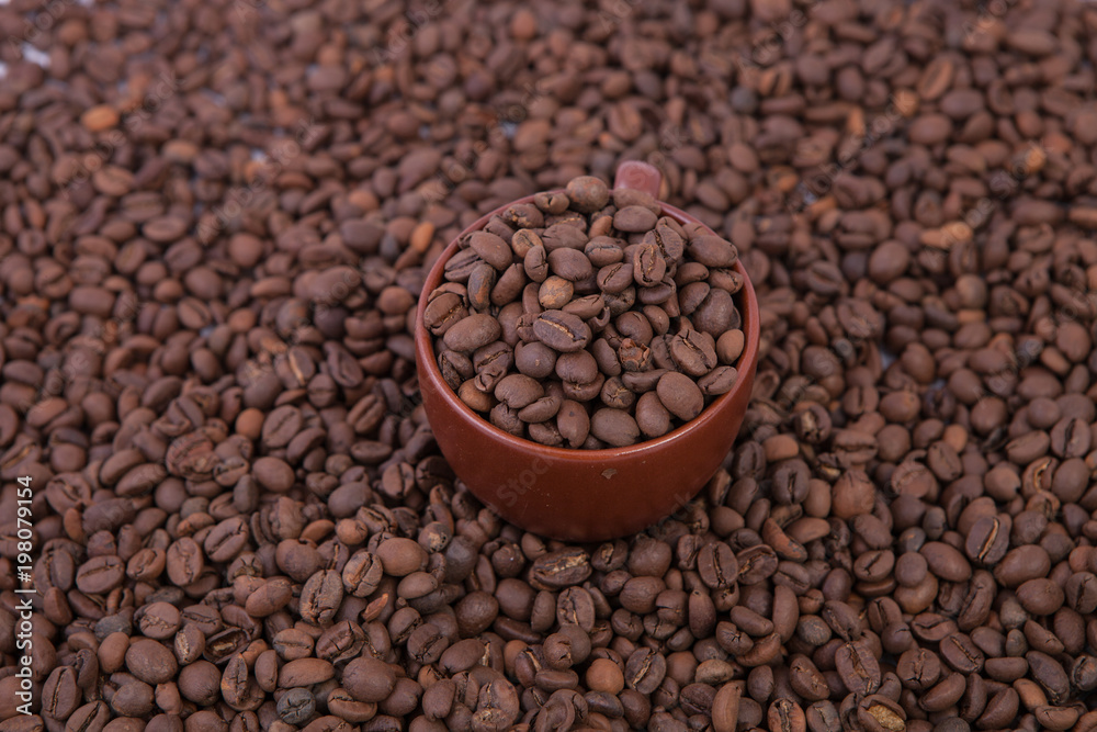 Fototapeta premium Cup of coffee on the coffee beans background