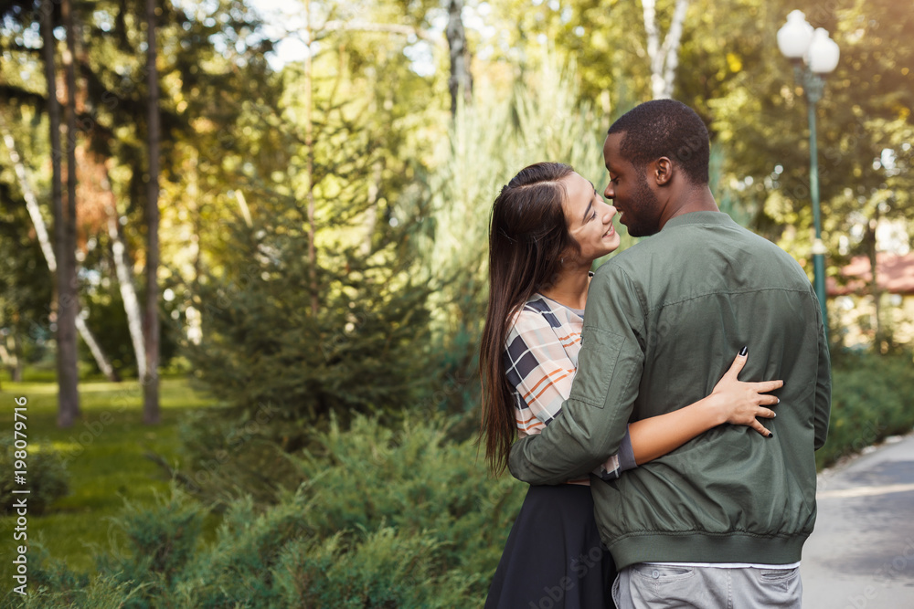 Happy couple hugging in park copy space Happy couple hugging in park copy space