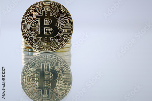 Golden Bitcoin facing the camera in sharp focus, closeup