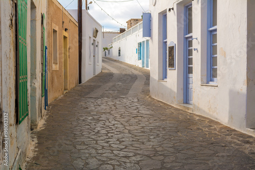 Historic narrow street in village of Tripiti on Milos island. Cyclades, Greece. © vivoo