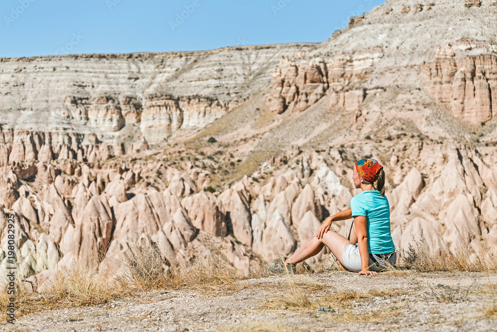 Traveler woman admiring splendid view of a scenic landscape in Cappadocia, Turkey