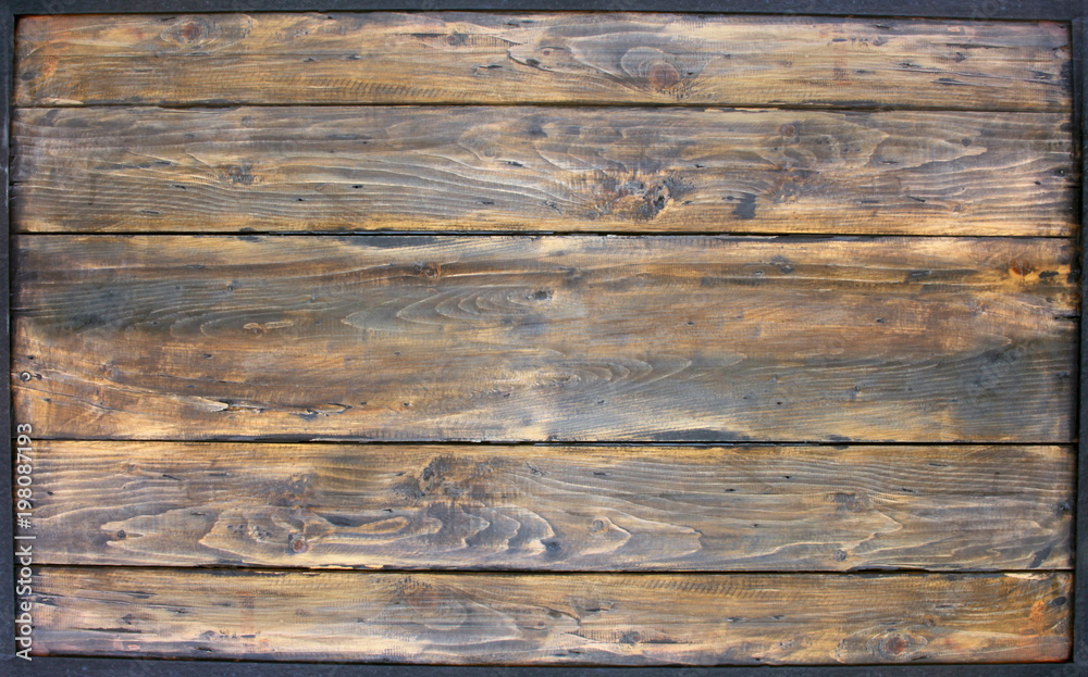 The wood surface is surrounded by a steel frame. The wood surface is surrounded by a steel frame.