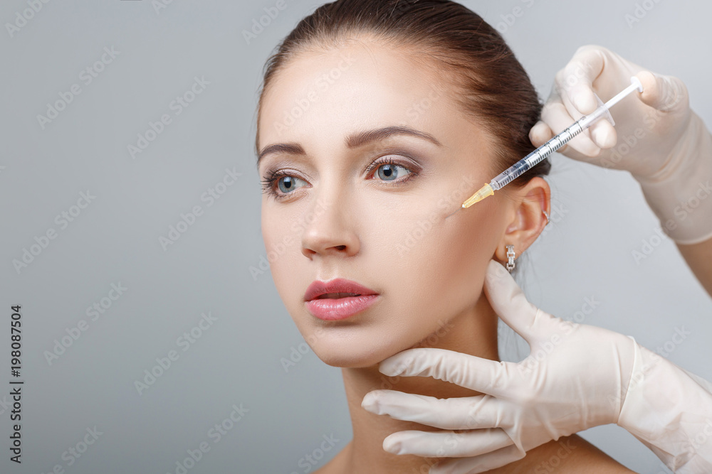 woman getting cosmetic injection woman getting cosmetic injection