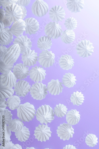 Fototapeta Naklejka Na Ścianę i Meble -  French vanilla meringue cookies on purple background with copy space.