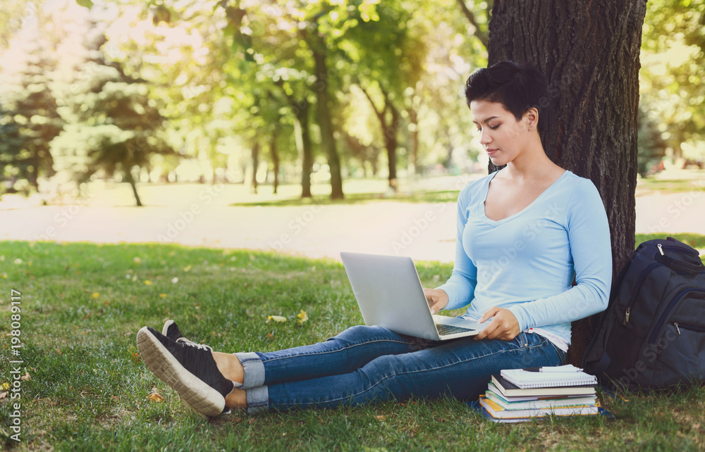 Handsome woman with laptop outdoors Handsome woman with laptop outdoors