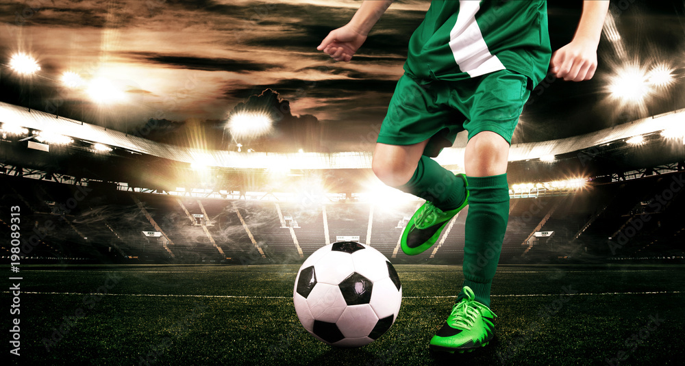 Fototapeta premium Kid - soccer player. Boy forward in football sportswear on stadium with ball. Sport concept.