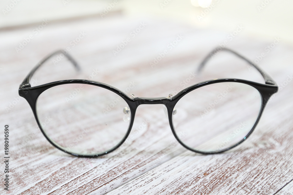 Women's fashionable eyeglass frame on white wooden background