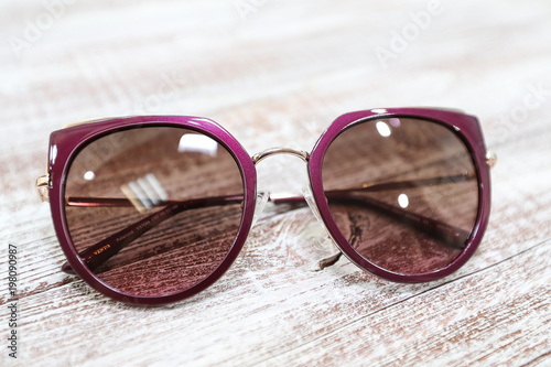  Women's stylish sunglasses on white wooden background