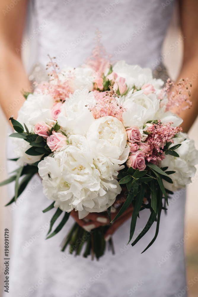 Bridal morning details. Wedding bouquet in the hands of the bride, selectoin focus