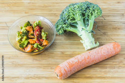 broccoli salad with carrot in glass bowl