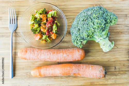 broccoli salad with carrot in glass bowl