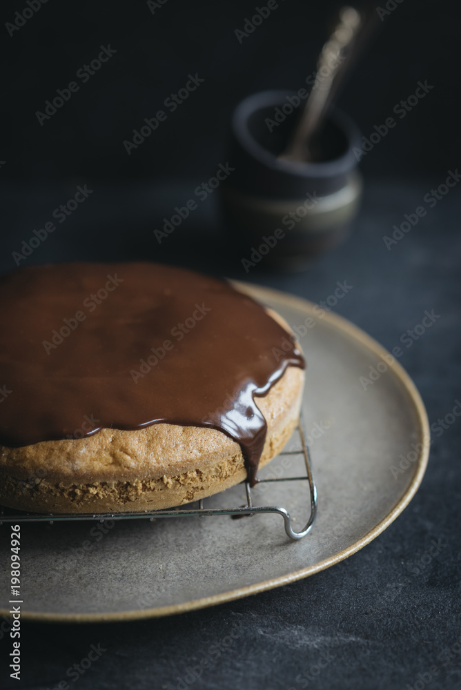 Fototapeta premium Sweet carrot cake glazed with chocolate served on the plate,selective focus