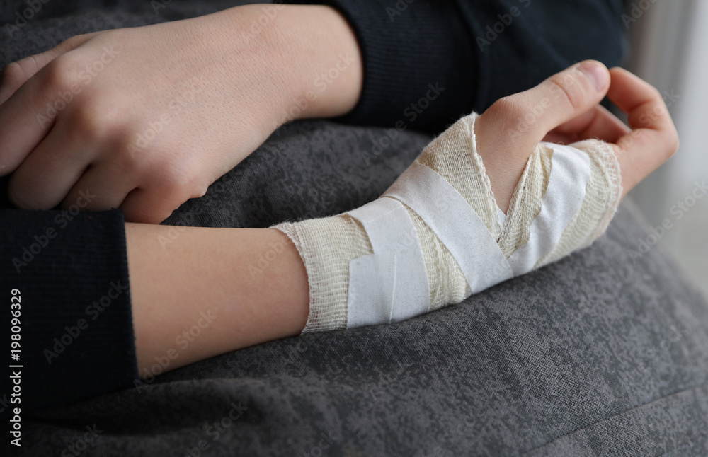 Fototapeta premium Child hand with gauze bandage on it.