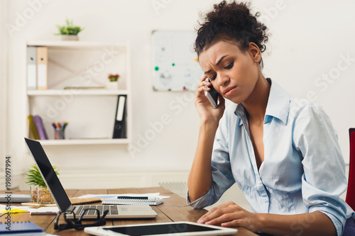 Concentrated business woman talking on phone