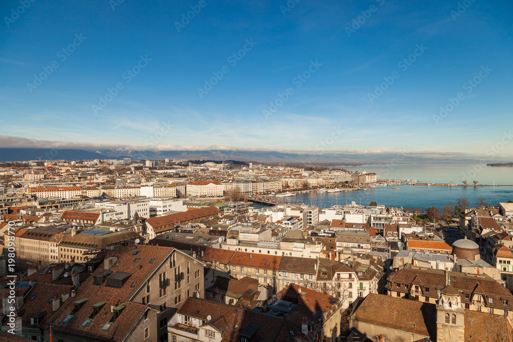 Geneva old city roofs and lake. Geneva aerial view from St. Pierre Cathedral bell tower. Winter day in Geneva, Switzerland.