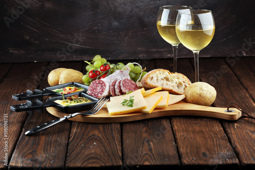 Photography Delicious traditional Swiss melted raclette cheese on diced boiled or baked potato