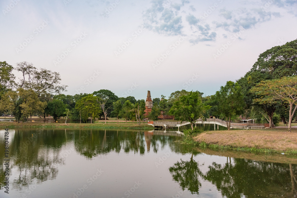City park in Ayutthaya with river and arch bridge