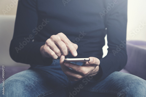 businessman hand phone sitting in sofa photo